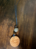 Flower pendant with blue bead